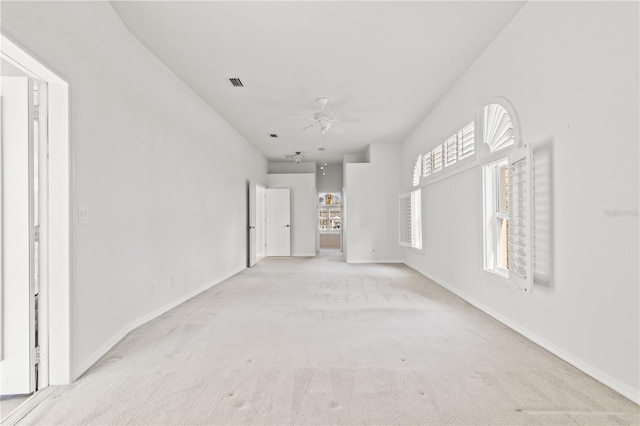 unfurnished room with light colored carpet and ceiling fan