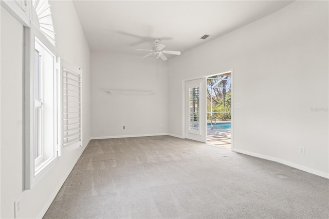 spare room featuring ceiling fan and carpet