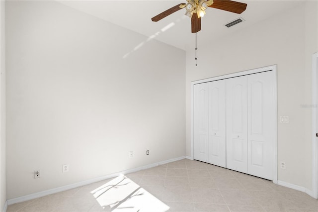 unfurnished bedroom with a closet, ceiling fan, and light tile patterned flooring