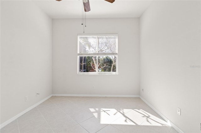 empty room with light tile patterned floors and ceiling fan