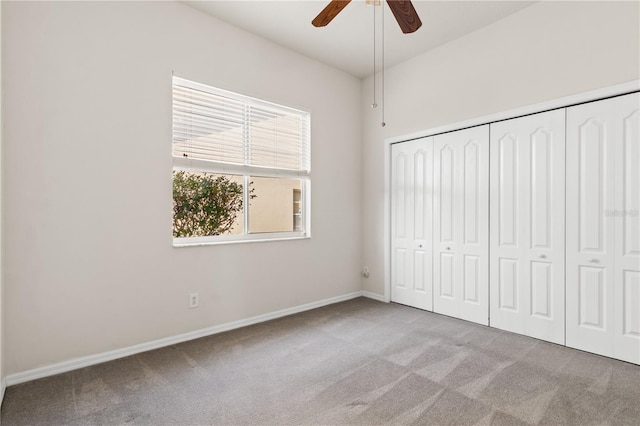 unfurnished bedroom with ceiling fan, light colored carpet, and a closet