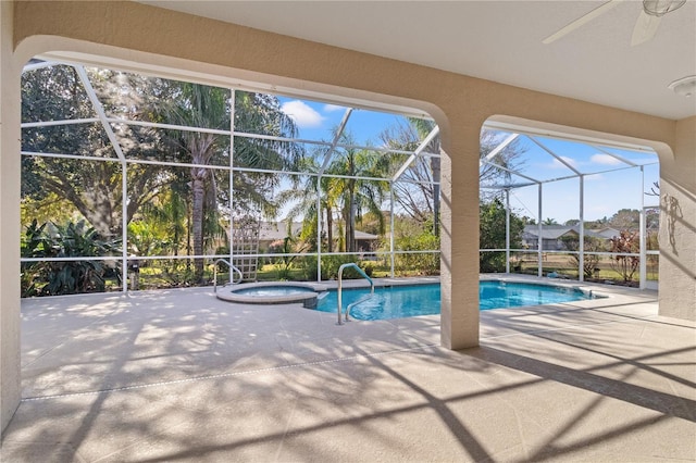 view of swimming pool featuring a lanai, a patio, and an in ground hot tub