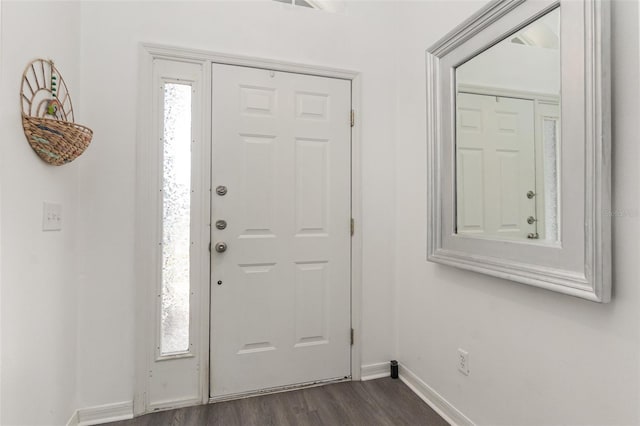 entrance foyer with dark wood-type flooring and a wealth of natural light