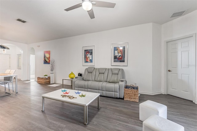 living room with dark wood-type flooring and ceiling fan