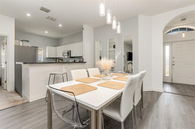 dining space with hardwood / wood-style flooring and a healthy amount of sunlight