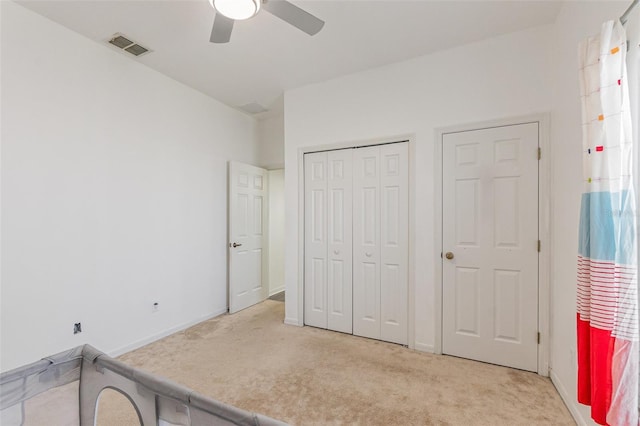 carpeted bedroom featuring a closet and ceiling fan