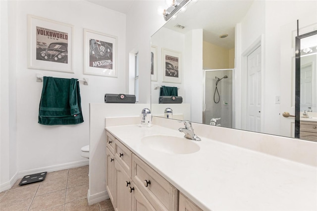 bathroom featuring vanity, a shower with shower door, tile patterned floors, and toilet