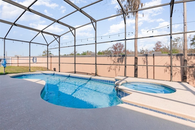 view of swimming pool featuring an in ground hot tub, a patio, and glass enclosure