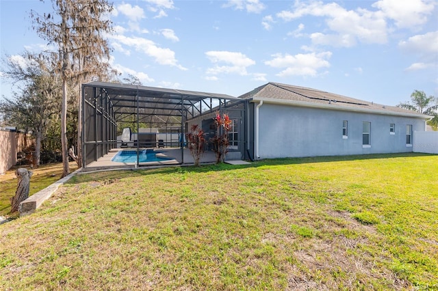 back of property featuring a yard, a lanai, a fenced in pool, and a patio