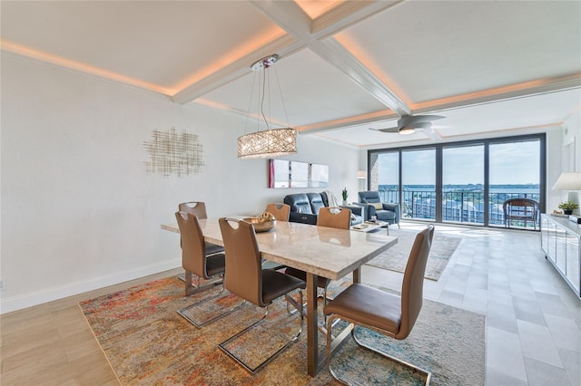 dining space featuring coffered ceiling, ceiling fan, a wall of windows, and beamed ceiling