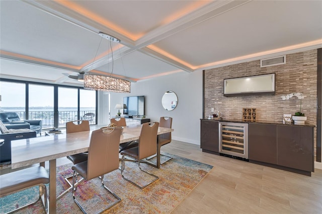 dining room with coffered ceiling, light hardwood / wood-style flooring, beverage cooler, and beamed ceiling