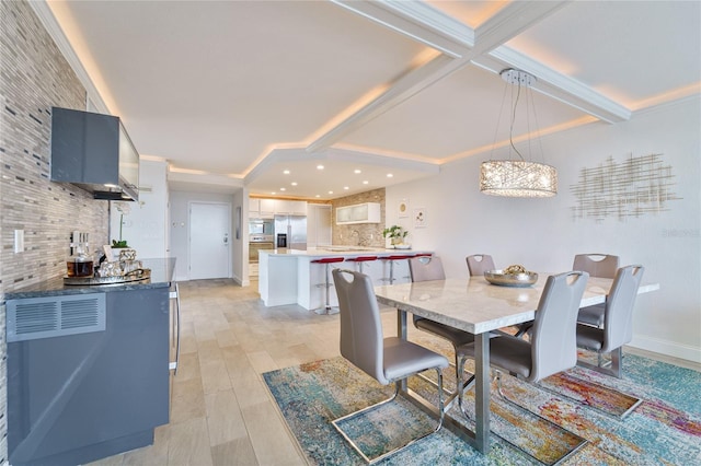 dining room featuring beamed ceiling and light wood-type flooring