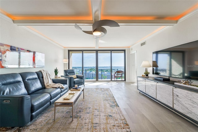 living room with crown molding, floor to ceiling windows, and hardwood / wood-style floors