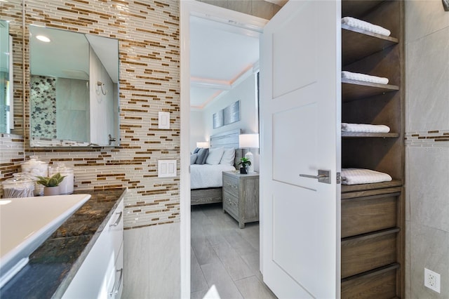 bathroom featuring vanity and backsplash