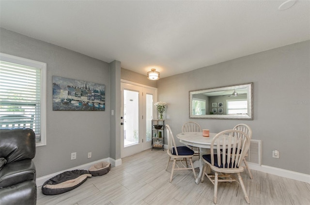 dining room with wood tiled floor and baseboards