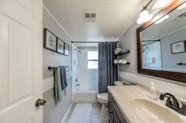 full bath featuring vanity, shower / bath combination with curtain, toilet, a wainscoted wall, and visible vents