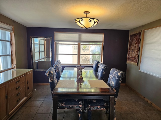 dining area with tile patterned flooring and a textured ceiling