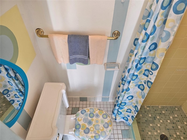 bathroom with tile patterned flooring and walk in shower