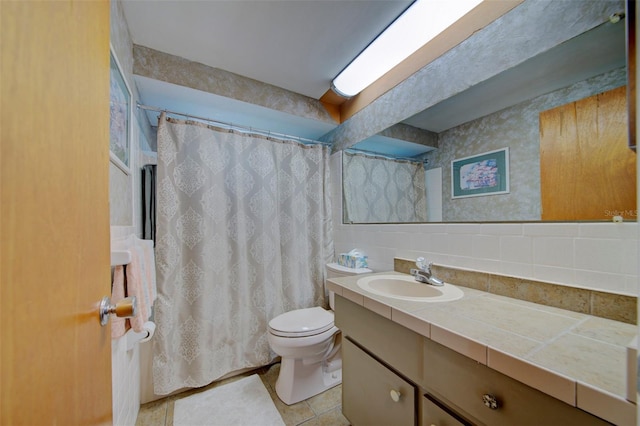 bathroom with tile patterned flooring, vanity, decorative backsplash, and toilet