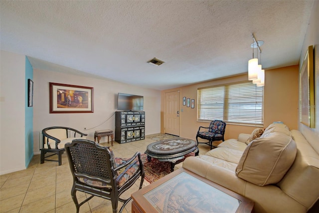 living room with light tile patterned flooring and a textured ceiling