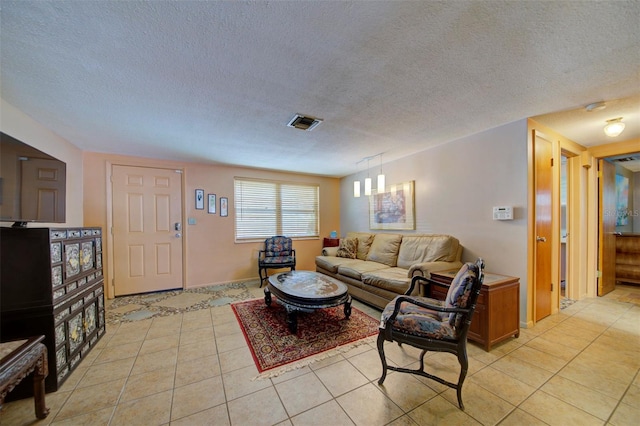 tiled living room featuring a textured ceiling