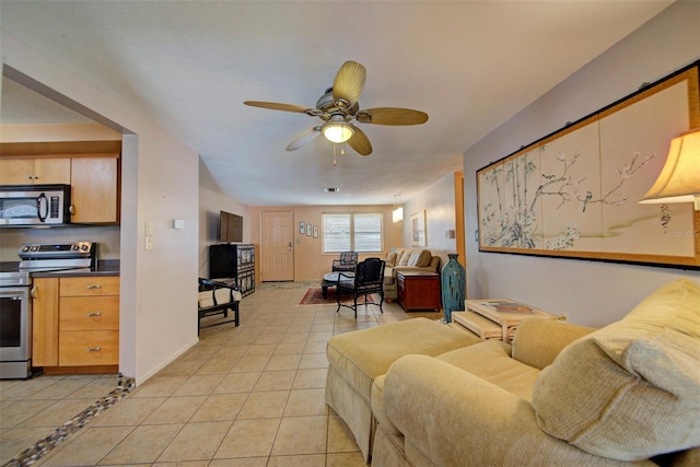 tiled living room featuring ceiling fan