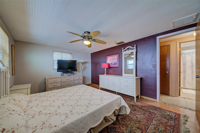 bedroom with wood-type flooring and ceiling fan