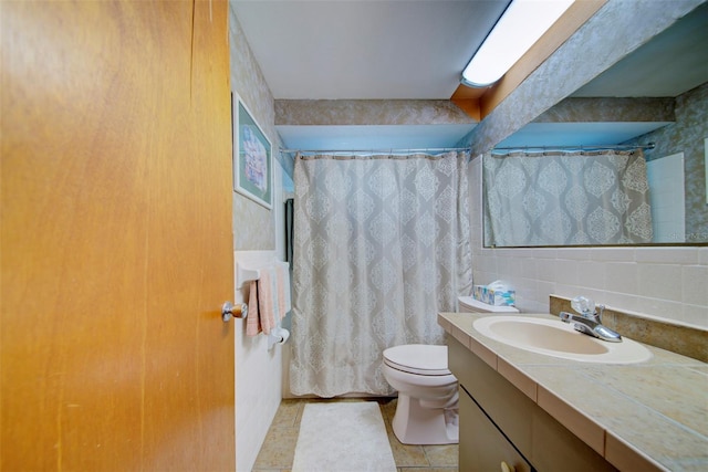 bathroom featuring tasteful backsplash, vanity, and toilet