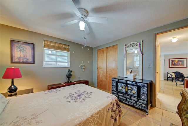 tiled bedroom featuring ceiling fan