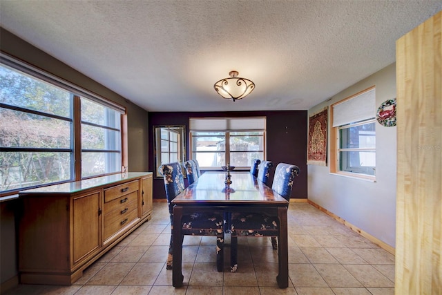 dining space featuring light tile patterned floors and a wealth of natural light