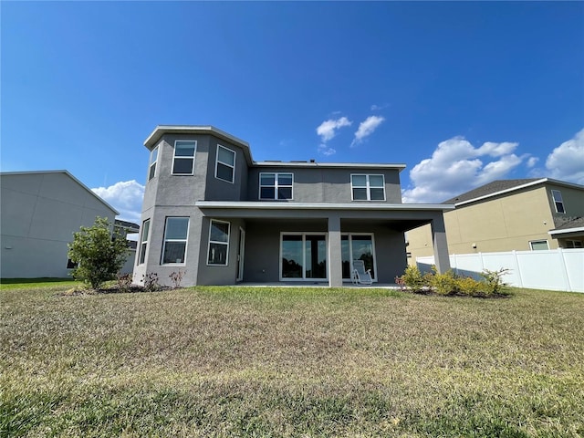 rear view of house with a yard and a patio area