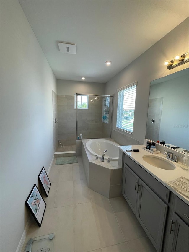 bathroom with tile patterned flooring, vanity, and separate shower and tub