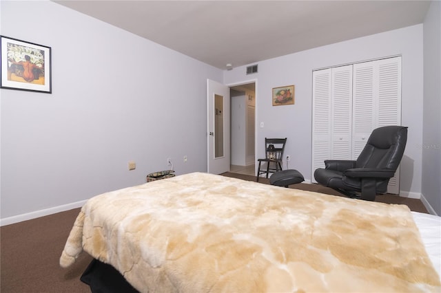 bedroom featuring dark colored carpet and a closet