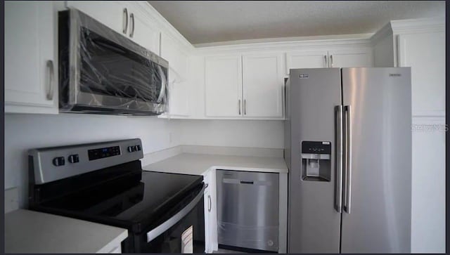 kitchen featuring white cabinetry and appliances with stainless steel finishes