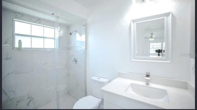 bathroom with walk in shower, vanity, and toilet