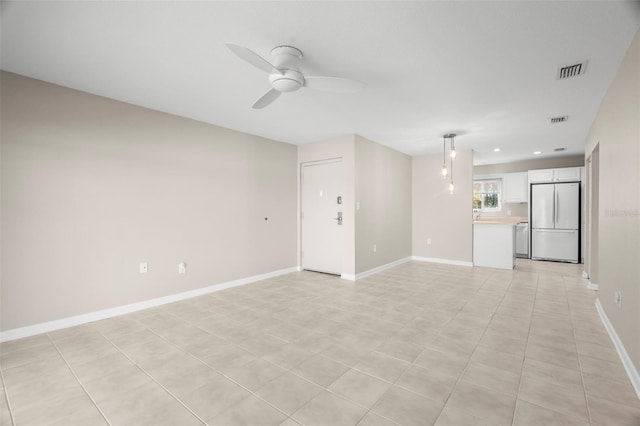 unfurnished living room with ceiling fan