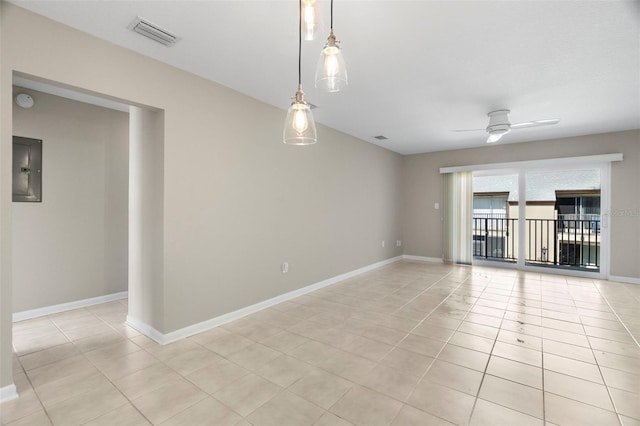 spare room featuring light tile patterned floors, electric panel, and ceiling fan