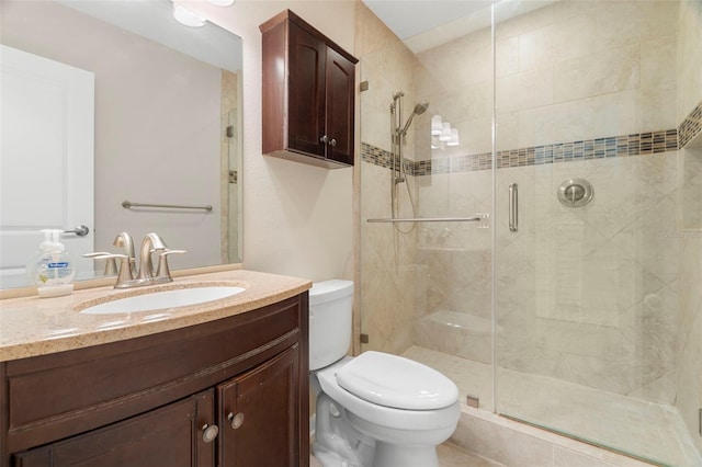 bathroom featuring walk in shower, vanity, and toilet