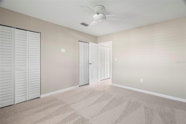 unfurnished bedroom featuring ceiling fan and light carpet