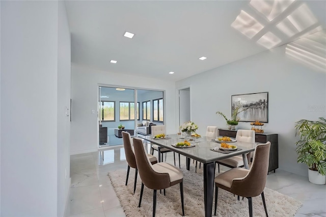 dining room featuring marble finish floor and recessed lighting