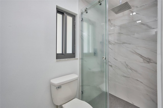 full bath featuring a marble finish shower and toilet