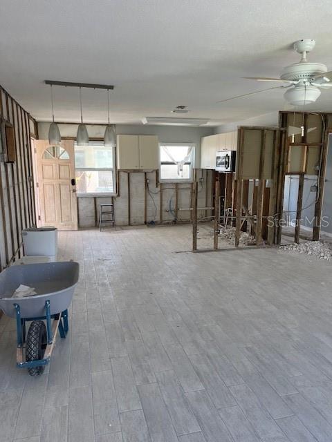 50 154th Ave Unit 50, Madeira Beach, FL 33708 - living area featuring light wood-type flooring and a ceiling fan