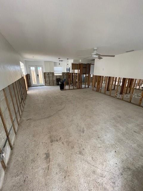 50 154th Ave Unit 50, Madeira Beach, FL 33708 - unfurnished living room featuring ceiling fan and french doors