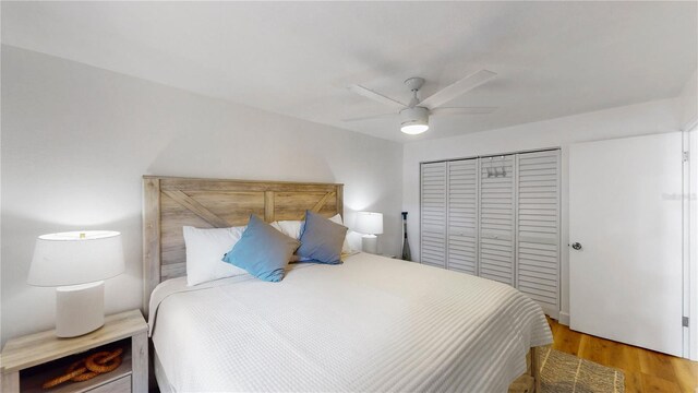 50 154th Ave Unit 50, Madeira Beach, FL 33708 - bedroom with a closet, light wood-style flooring, and a ceiling fan