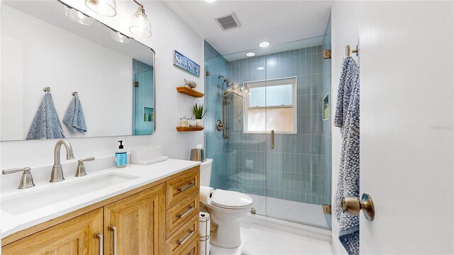 50 154th Ave Unit 50, Madeira Beach, FL 33708 - bathroom featuring toilet, a stall shower, vanity, and recessed lighting