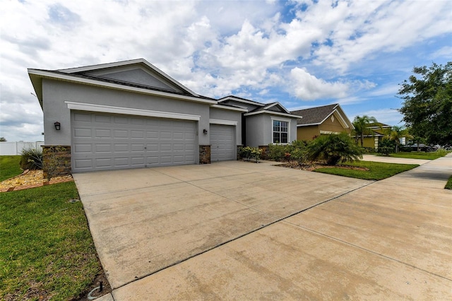 single story home with a garage and a front lawn