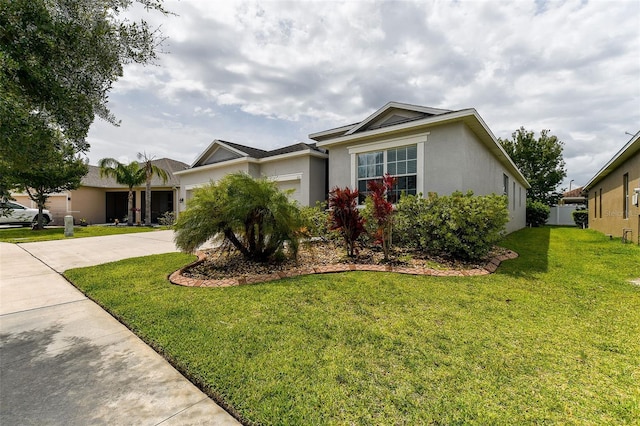 ranch-style house featuring a garage and a front lawn