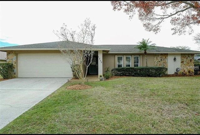 single story home with a garage and a front yard