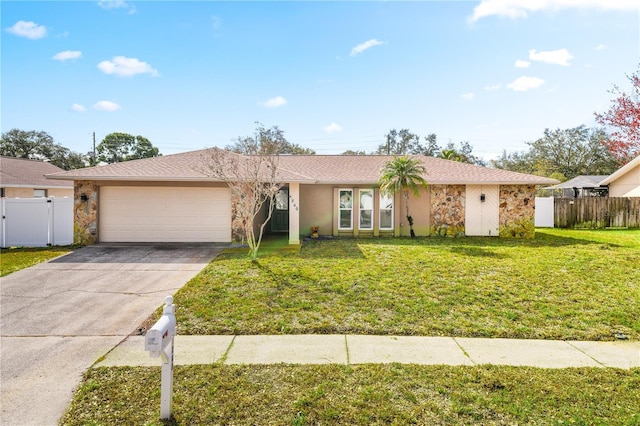 single story home with a garage and a front lawn