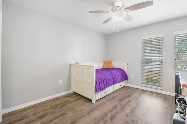 bedroom with ceiling fan and hardwood / wood-style floors